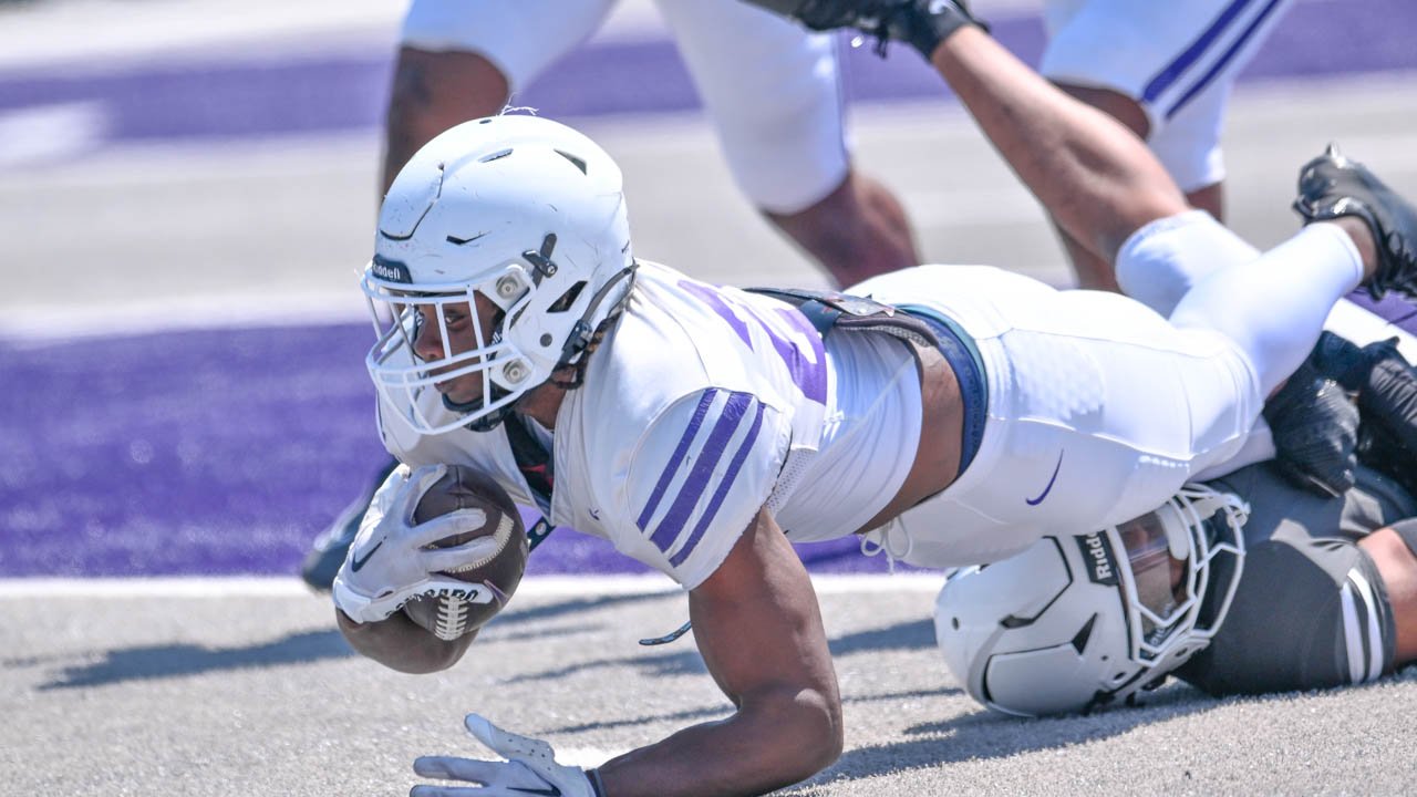 UCA running back Cam Young stretches being tackled during the Bears football spring game